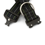 Black dog collar with metal buckle and clip on a white background