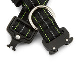 Black dog collar with green stitching and metal D-ring on a white background